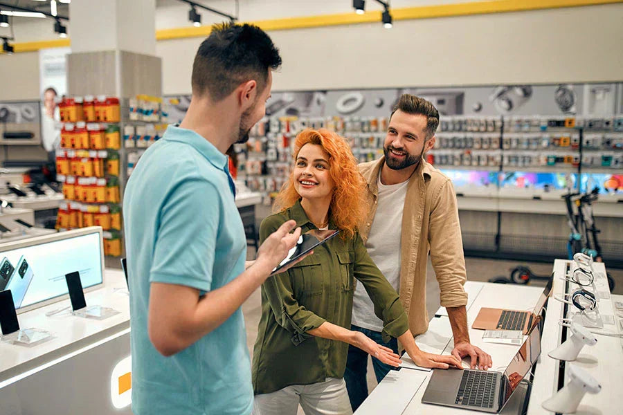 Customer selling unused electronics during in-store evaluation at PayMore Wake Forest